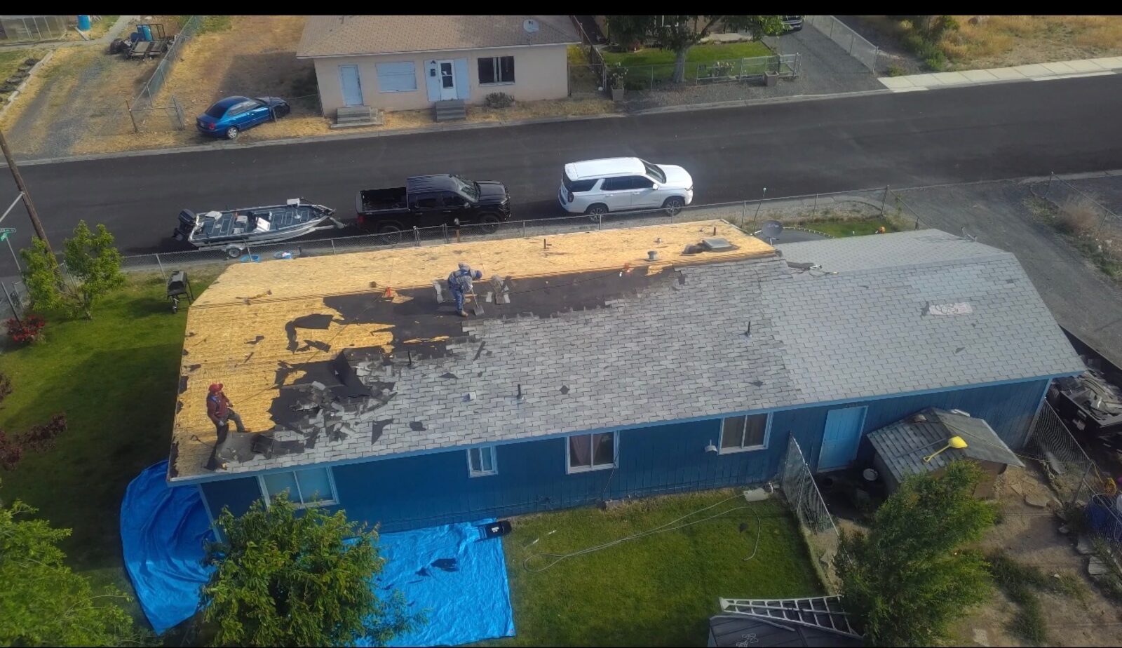 Roof tear-off in progress on rural home