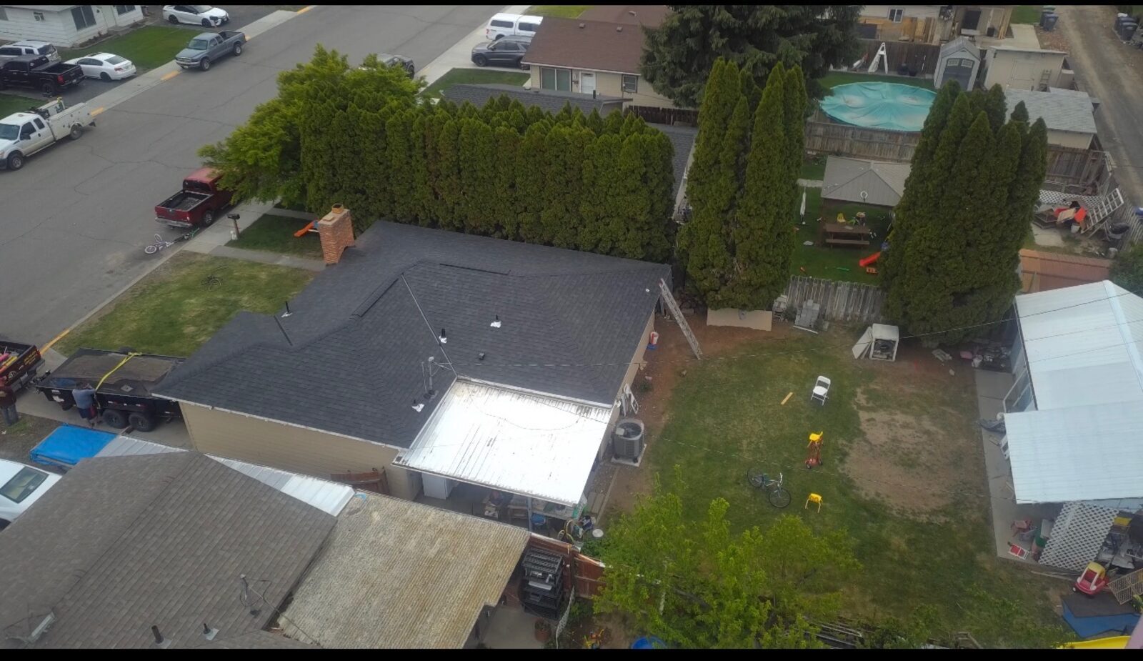 Completed dark shingle roof on in-town home